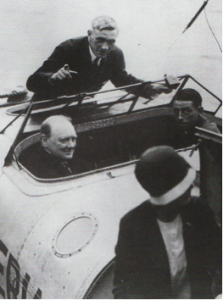 Winston Churchill and John Lankester Parker in the cockpit with Oswald Short raising a finger